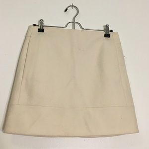 A cream wool skirt.