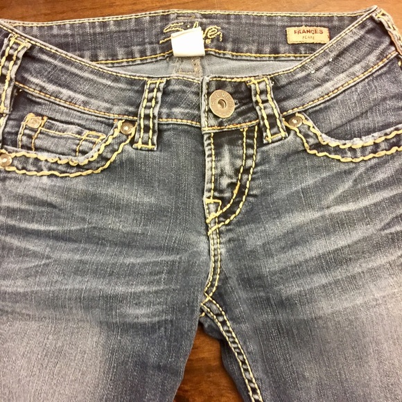 Silver boot cut jeans.
