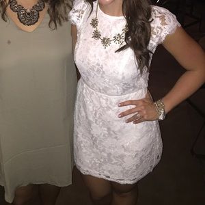 Short white lace dress with open back