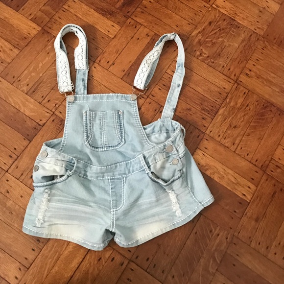 A pair of never worn short light denim overalls