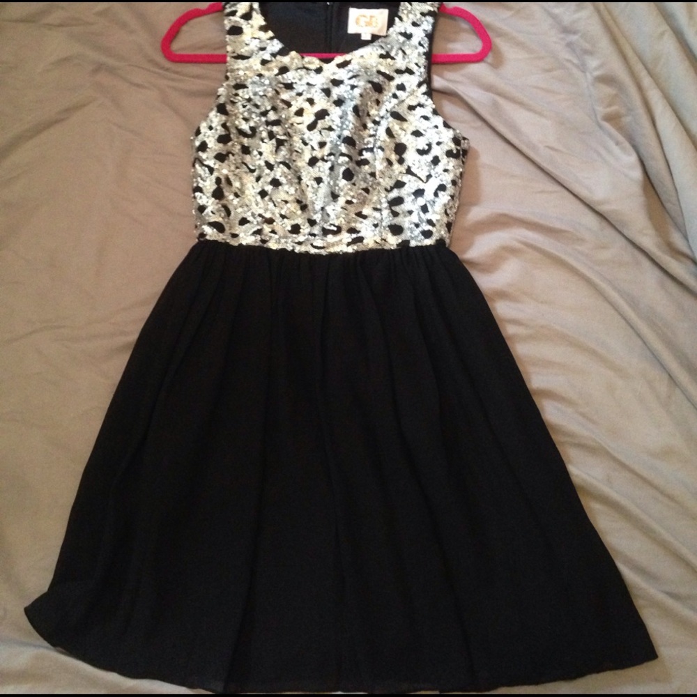 GB dress size S , sparkly silver and black.