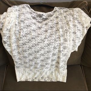 Lace short sleeve top. Fitted at hips