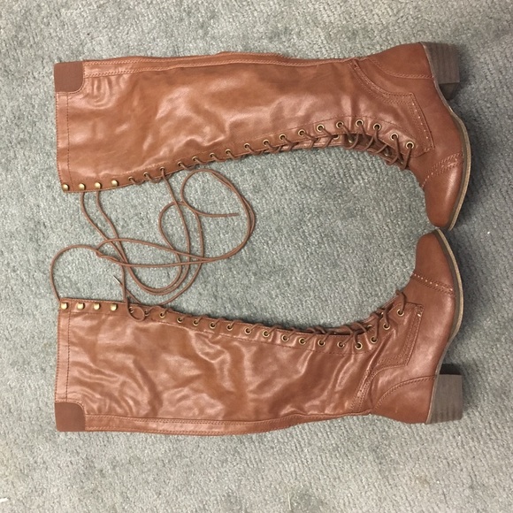 brown over-the-knee lace-up boots.