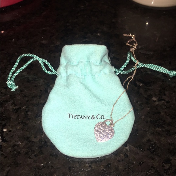 Tiffany & Co. Heart necklace with cursive writing.