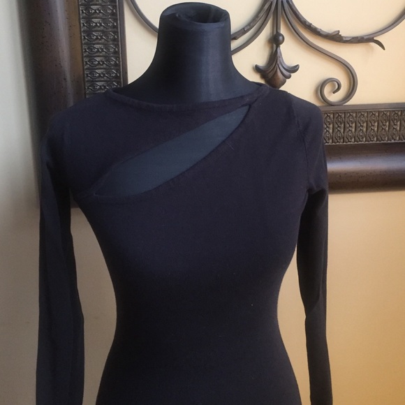 Black sweater dress with a slit at neck.