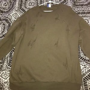Over sized green sweater with cuts and scratches