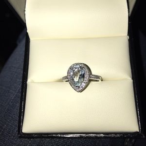 Teardrop aquamarine ring with diamonds around it