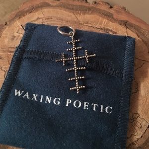 Waxing poetic cross charm.