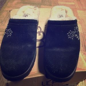 Black UGG slip on shoe with small heel.