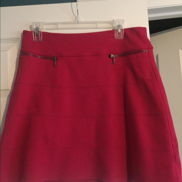 Slightly above the knee, red/pink skirt