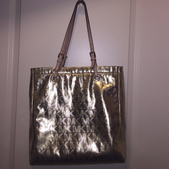 Used Micheal Kors purse in metallic gold