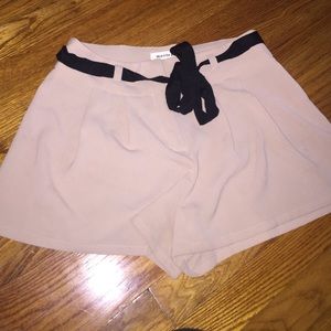 Tan flowy shorts with black belt