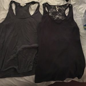 2 grey large tanks. One has lace on the back.