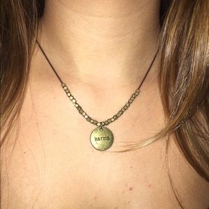 Karma pendent on leather string