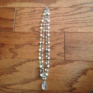 Silver and pearl like. No tarnish
