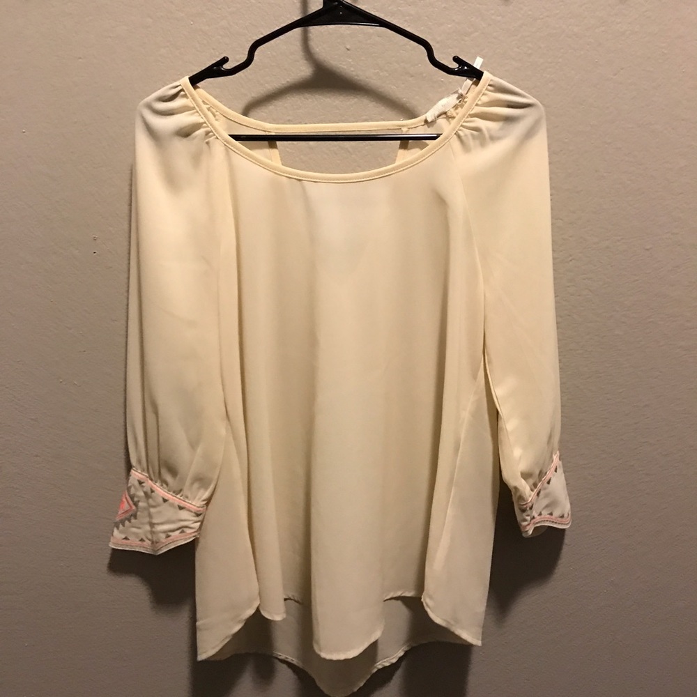 Cream blouse with neon sleeve embroidery detail
