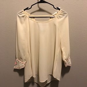 Cream blouse with neon sleeve embroidery detail