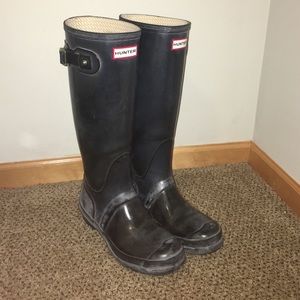 Shiny black tall hunter boots, size 7 in women's.