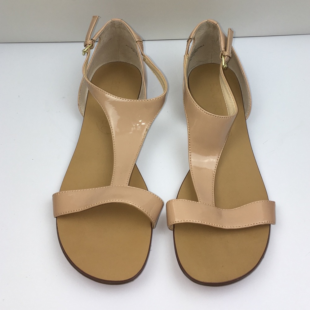 Nude patent sandals with side gold buckle.