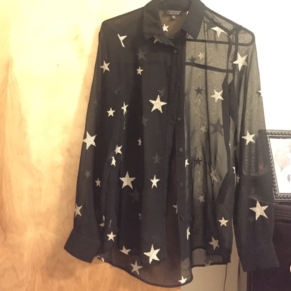 Long sleeve black blouse with gold thread stars.