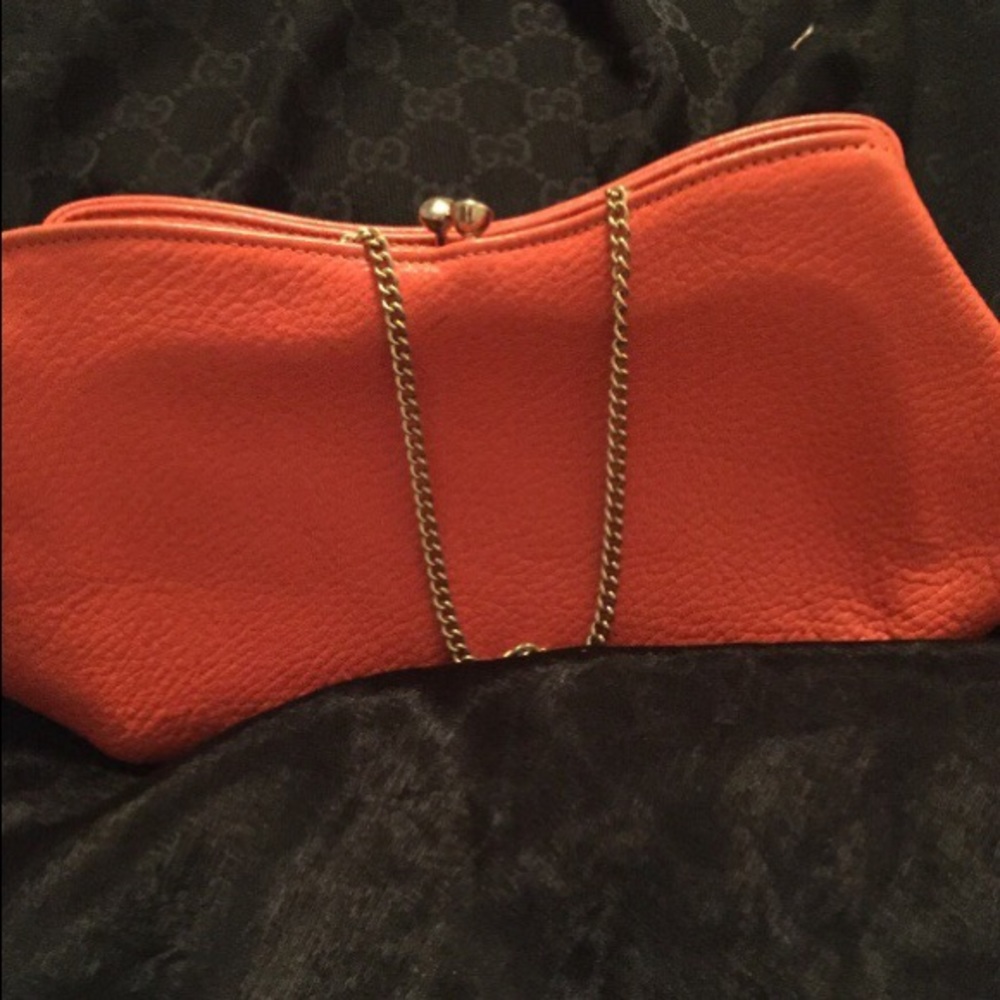 Gorgeous Orange leather clutch with metal chain.