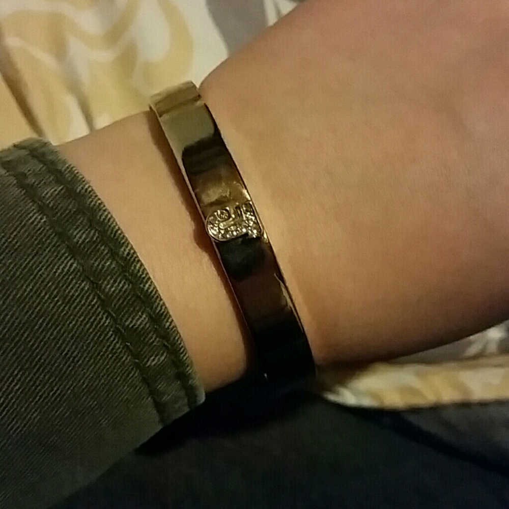 Gold bracelet with a rhinestone J