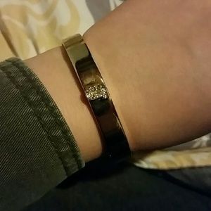 Gold bracelet with a rhinestone J