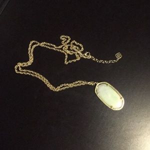 Gold Kendra Scott necklace with white stone.