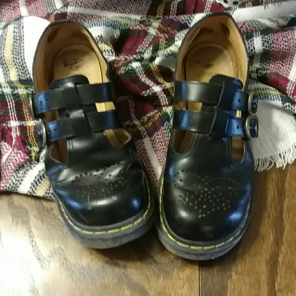 Women's black shoes with yellow stitching...