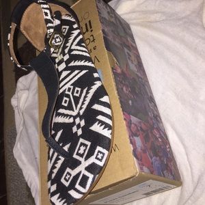 Black and white TOMS sandals