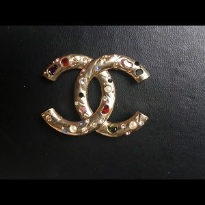 Sold Chanel multi color gem brooch