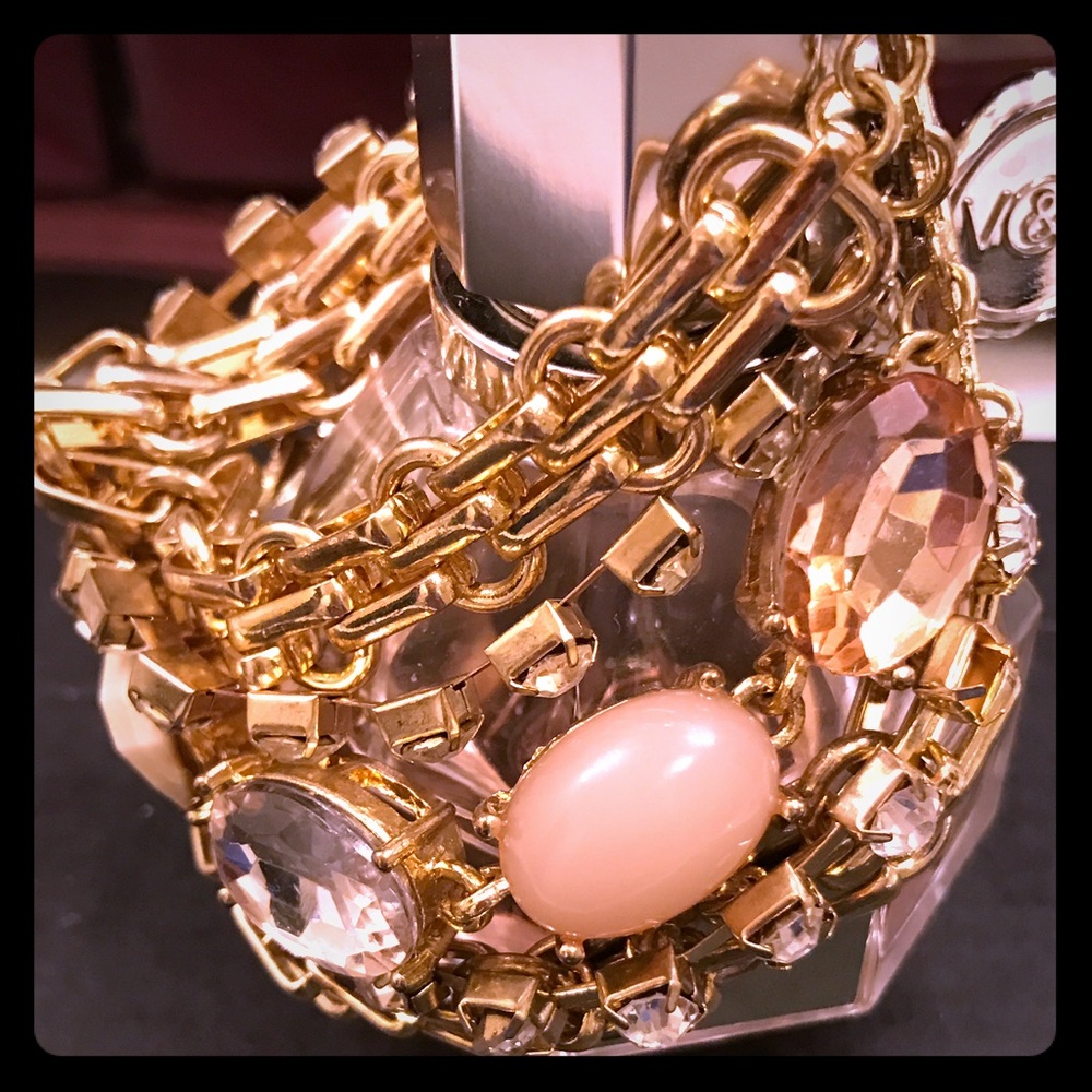 Chunky rhinestone and gold chain bracelet.