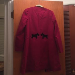 Dark red long coat with dog figure behind