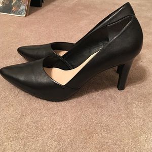 Black faux leather pumps.