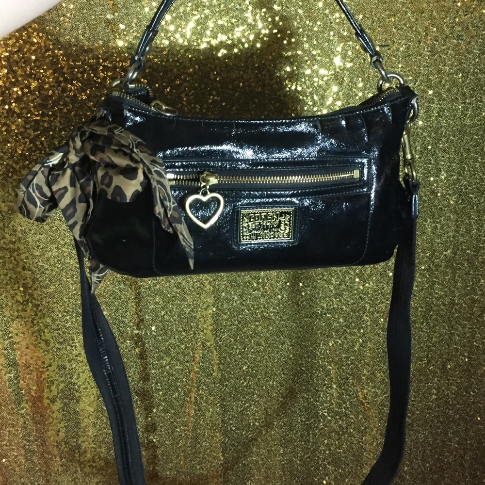 Black coach bag with cheetah bow