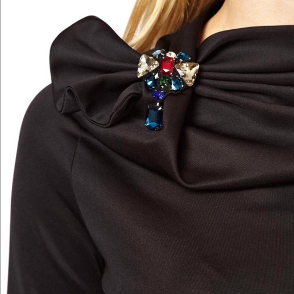 Black dress with attached brooch stretch material