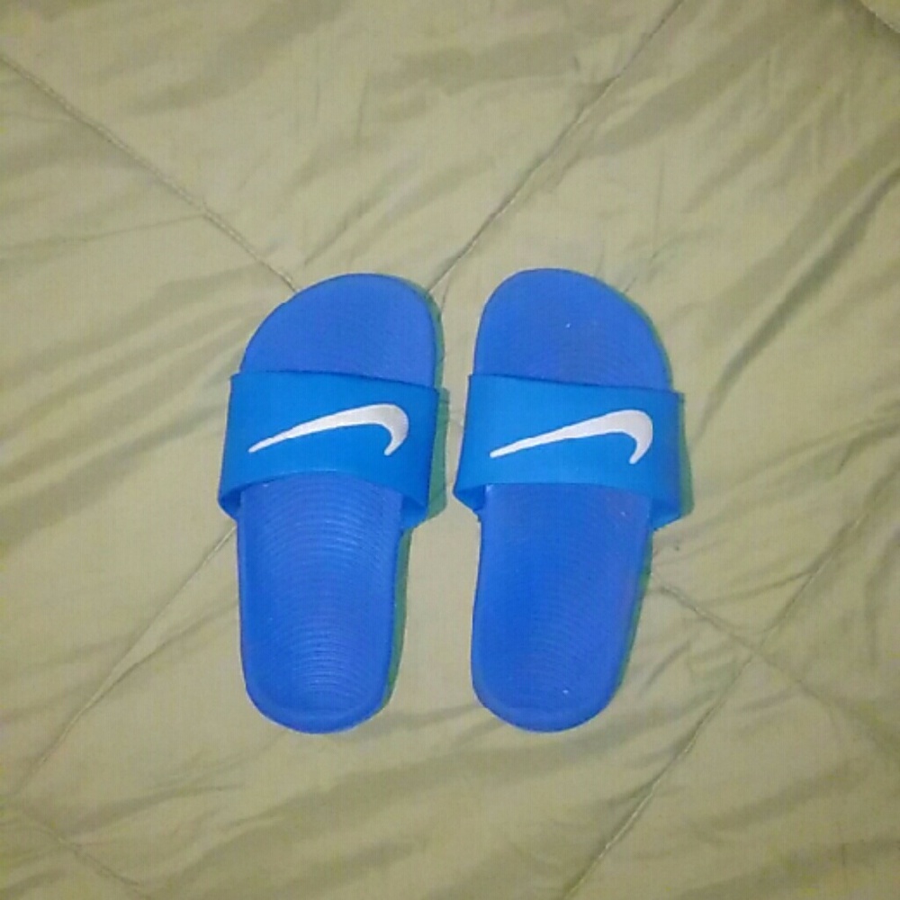 Blue and white Nike slippers