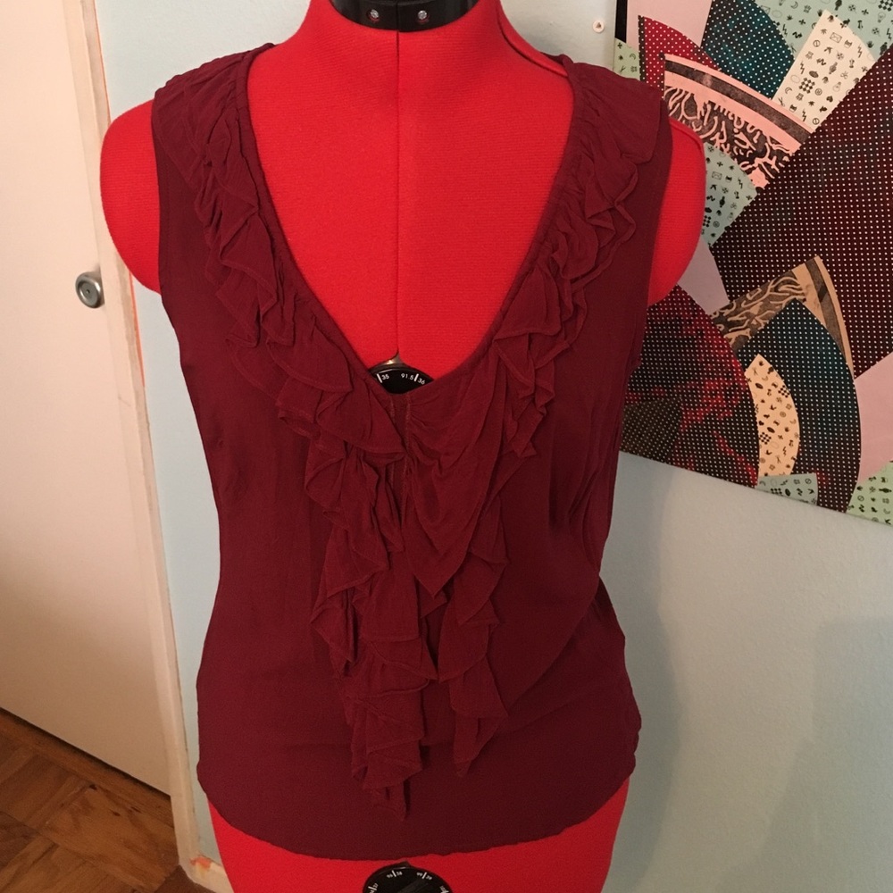 Maroon blouse with ruffle front detail.