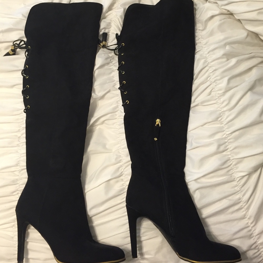 Thigh high black boots with lace up detail