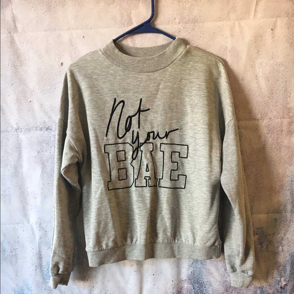 Gray sweatshirt with writing "not your bae"