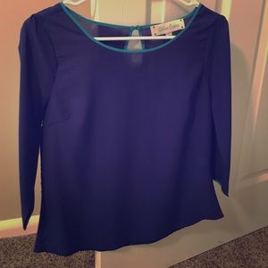 Blouse w/ light blue trim around neck and sleeves