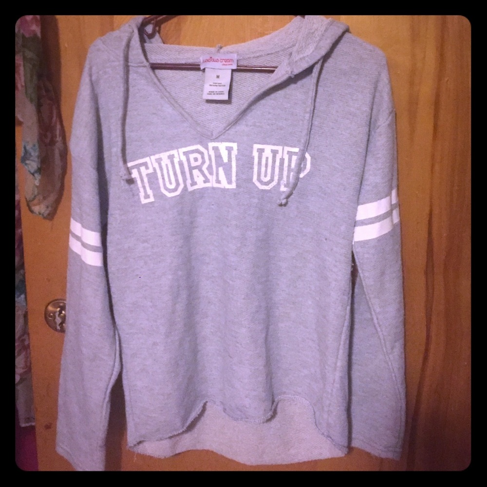 Gray and white sweater that says "Turn up"