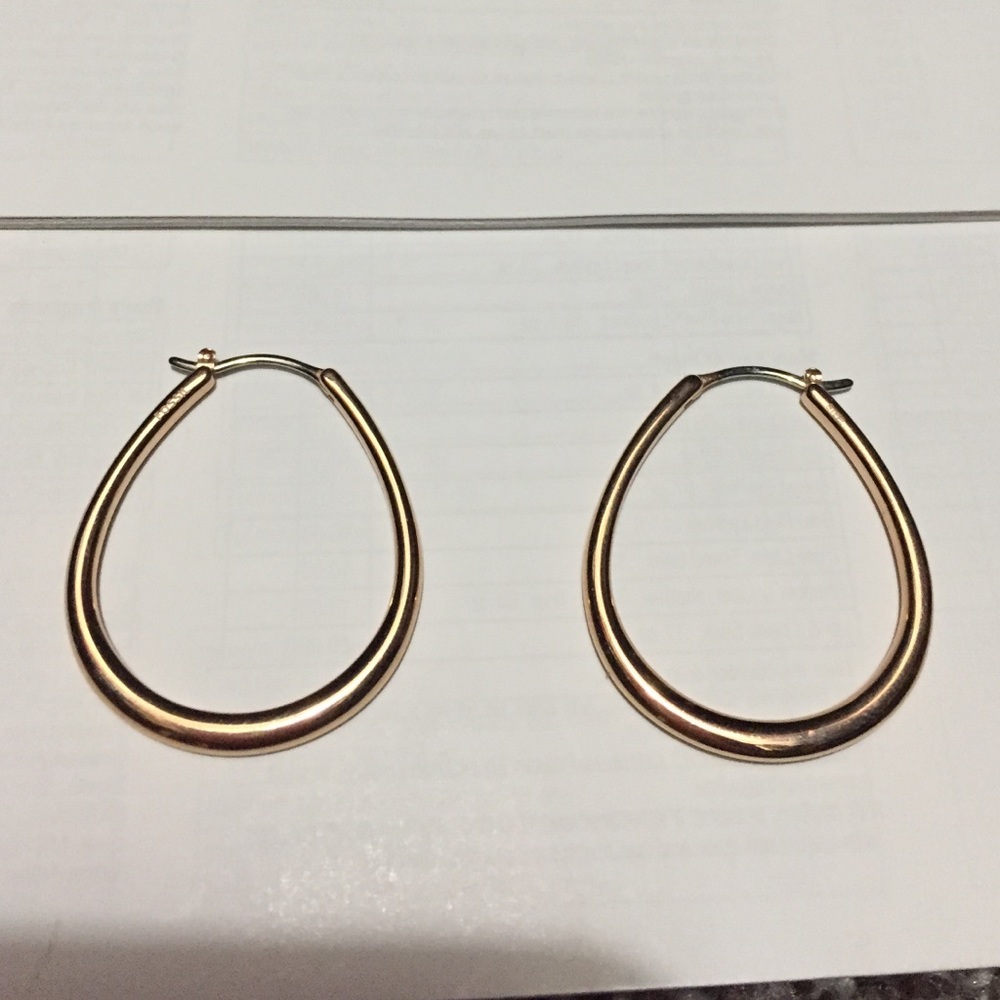 Rose gold hoop earrings.