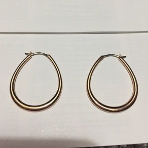 Rose gold hoop earrings.