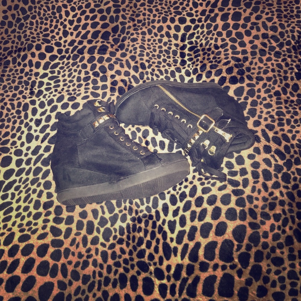Black and gold wedge sneakers .