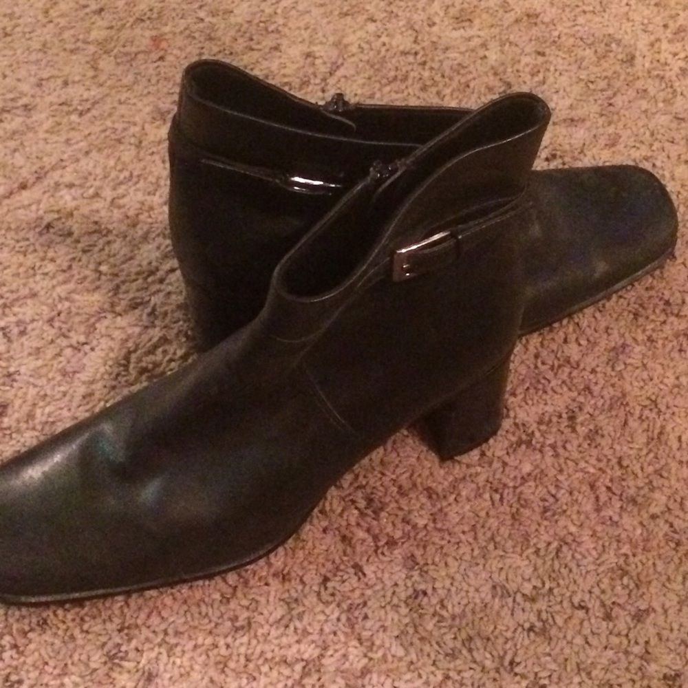 Black booties with a buckle on the side