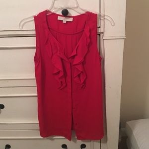 Red sleeveless ruffle button-down top.