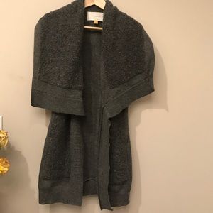 Long gray sweater vest with oversized collar.