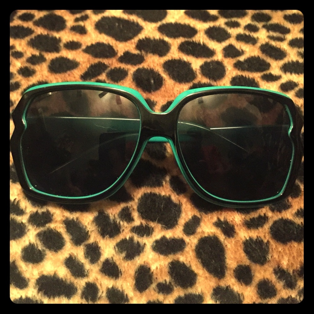 High fashion turquoise and black sunglasses.