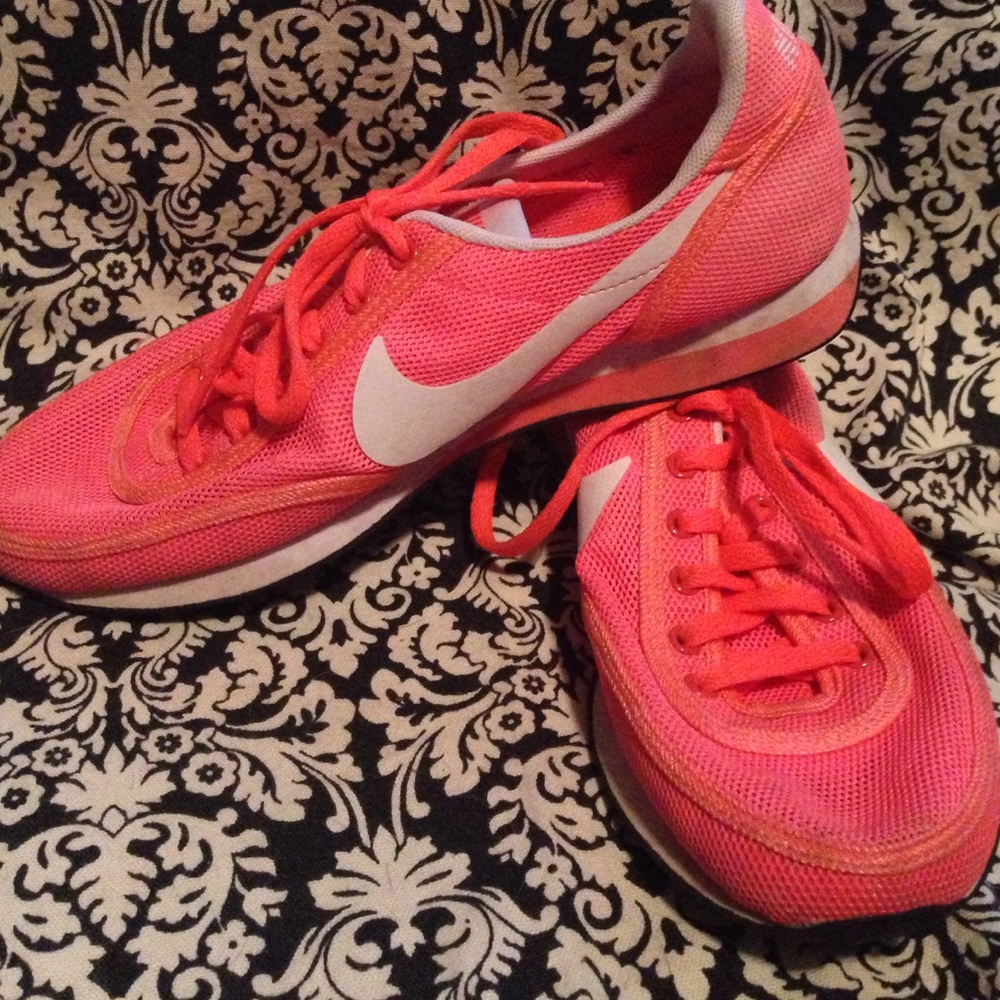 Coral colored Nike running shoes